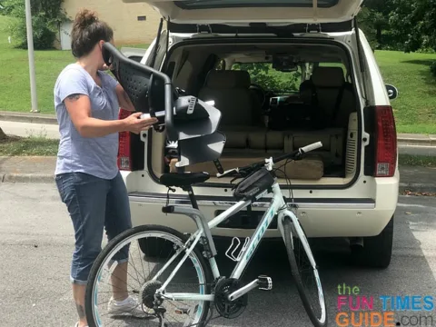 Removing the child bike seat before loading my bike into the SUV.