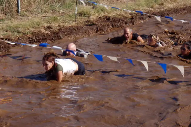 A mud pit with some obstacles at the mud run.