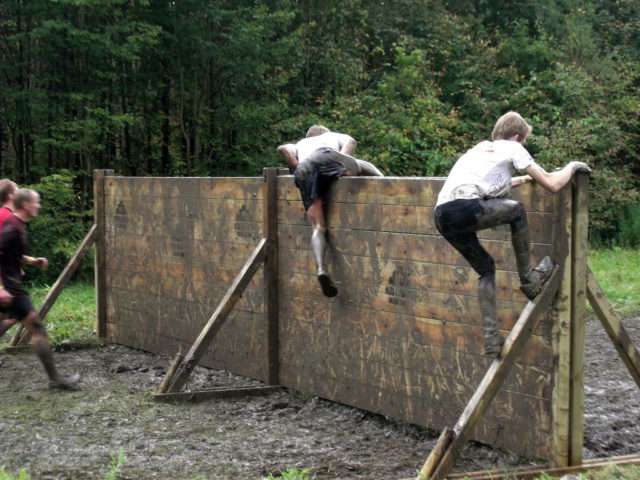 Sometimes you're able to scale a wall on your own at a mun run. photo There are plenty of people there to lend a helping hand - if you need it - when climbing walls on a mud run. 