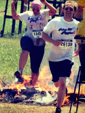 Jumping over fire at the mud run. 